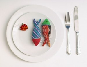 3105705-concept-diet-dinner-with-two-toy-fish-knife-and-fork-and-flower-on-white-plate